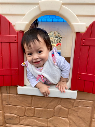 Toddler playing in play house